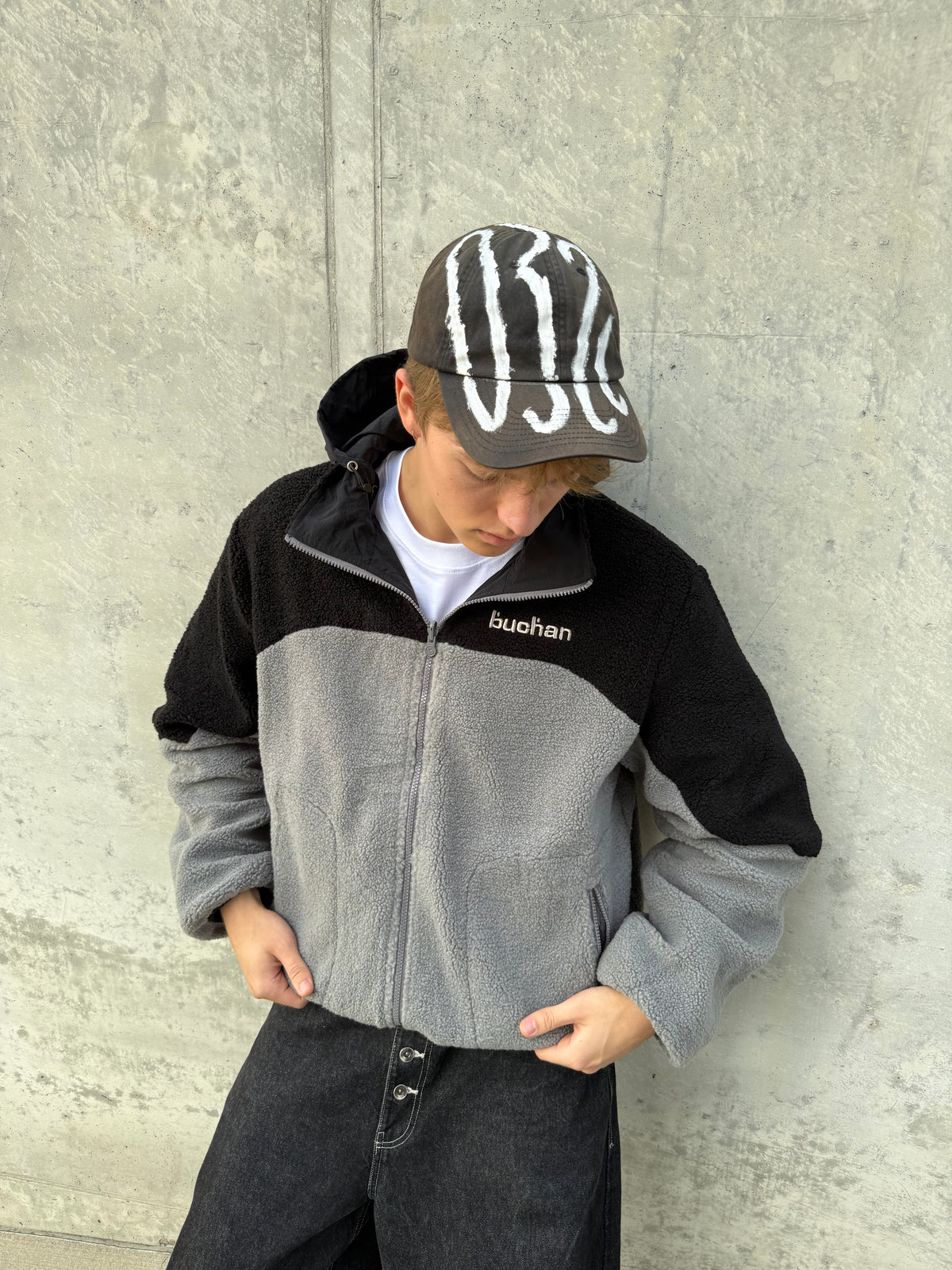 Model wearing the reversible Buchan fleece in black, black and grey colour-blocked fleece, front view